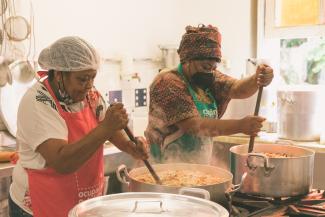 A photo of two black women cooking