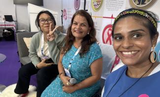 Three women attending an AIDS conference